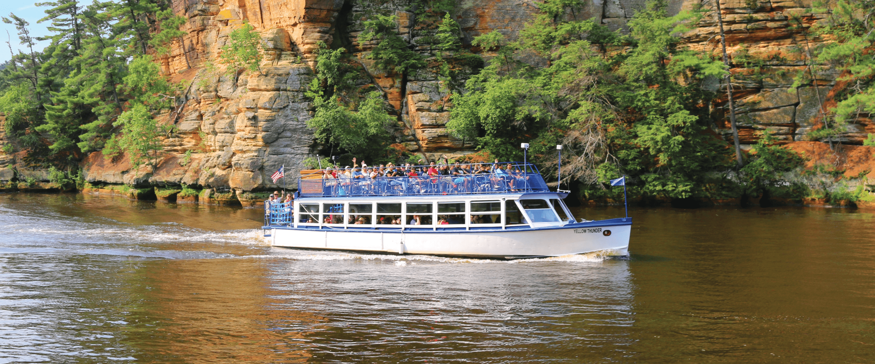 Upper Dells scenic boat tour moving through sandstone bluffs